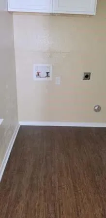 a kitchen with stainless steel appliances granite countertop a sink a stove and microwave with wooden floor