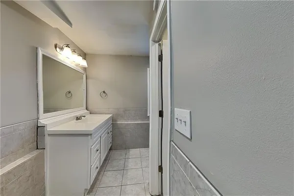 a bathroom with a sink a mirror and a bathtub