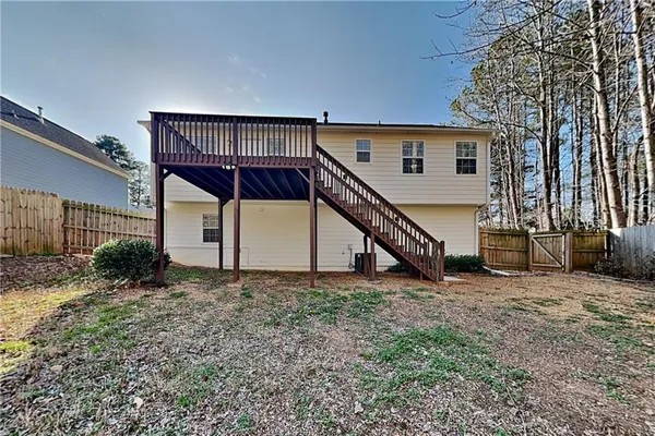 a view of a house with a wooden deck