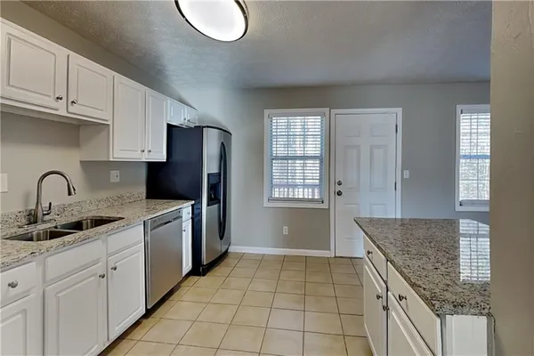 a kitchen with stainless steel appliances granite countertop a stove sink and cabinets