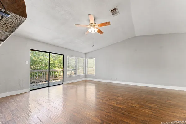 wooden floor in an empty room with a window