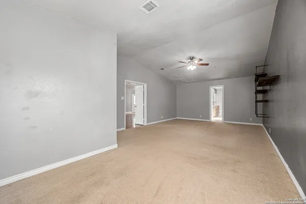 a view of a livingroom with a ceiling fan and window