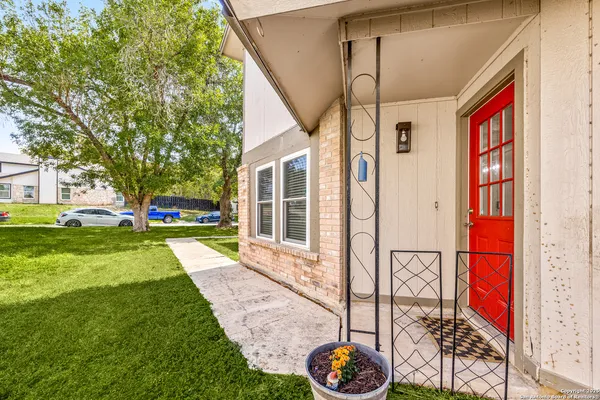 a front view of a house with a yard table and chairs