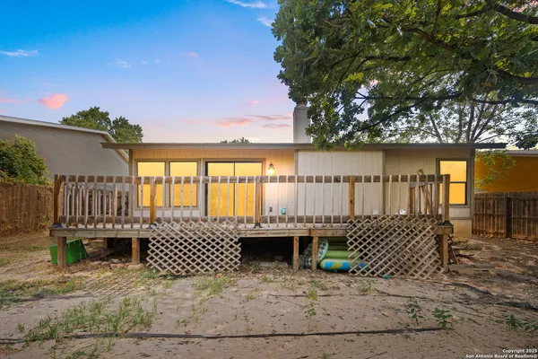 a view of a deck with table and chairs a barbeque with wooden fence and floor