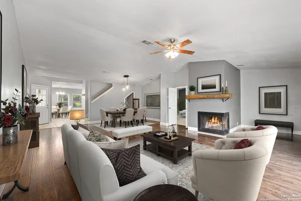 a living room with furniture chandelier and a fireplace