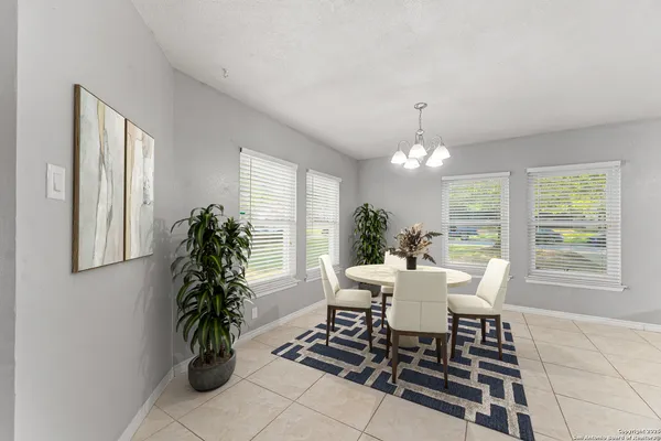 a dining room with furniture and window