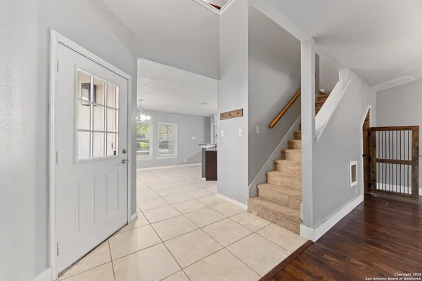 a view of entryway with wooden floor and stairs