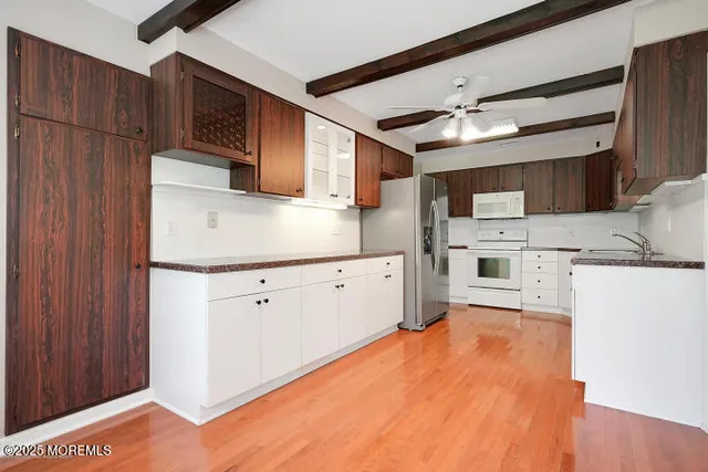 a kitchen with stainless steel appliances a refrigerator and a stove top oven