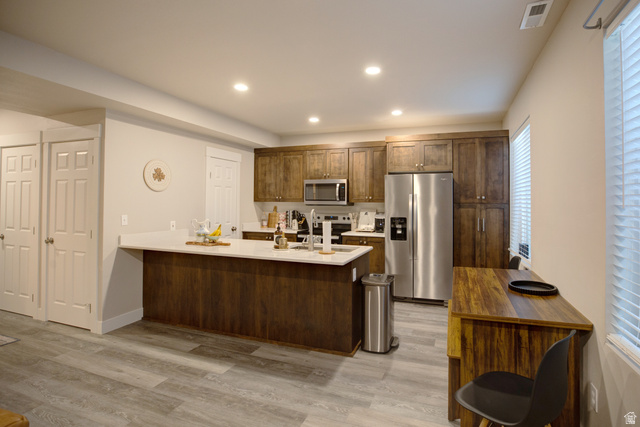 983 South 950 West Provo, UT 84601 - Photo 27 of 56 Modern kitchen featuring wood-finish cabinetry, stainless steel appliances, and light-toned countertops