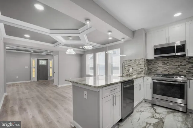 a kitchen with stainless steel appliances granite countertop a stove and a sink