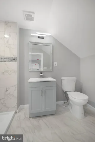 a bathroom with a sink toilet and mirror