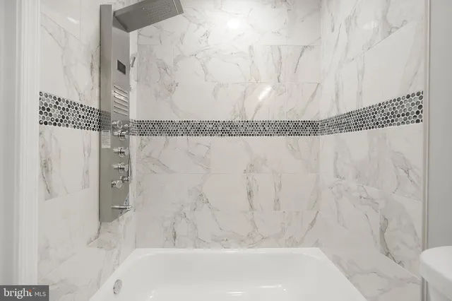 a bathroom with a bathtub and shower