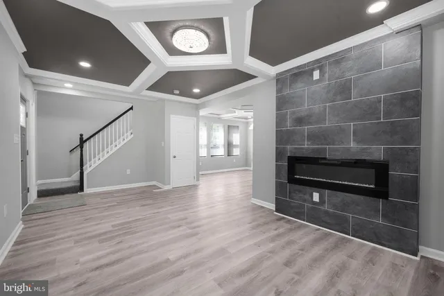 a view of an empty room with a fireplace and a window