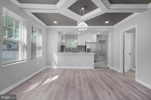 a view of kitchen with cabinets and wooden floor