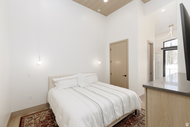 160 Ridgeview Street, Unit 7B Brian Head, UT 84719 - Photo 23 of 40 Primary bedroom with recessed lighting, wood finished floors, built-in dressers and a high wood ceiling