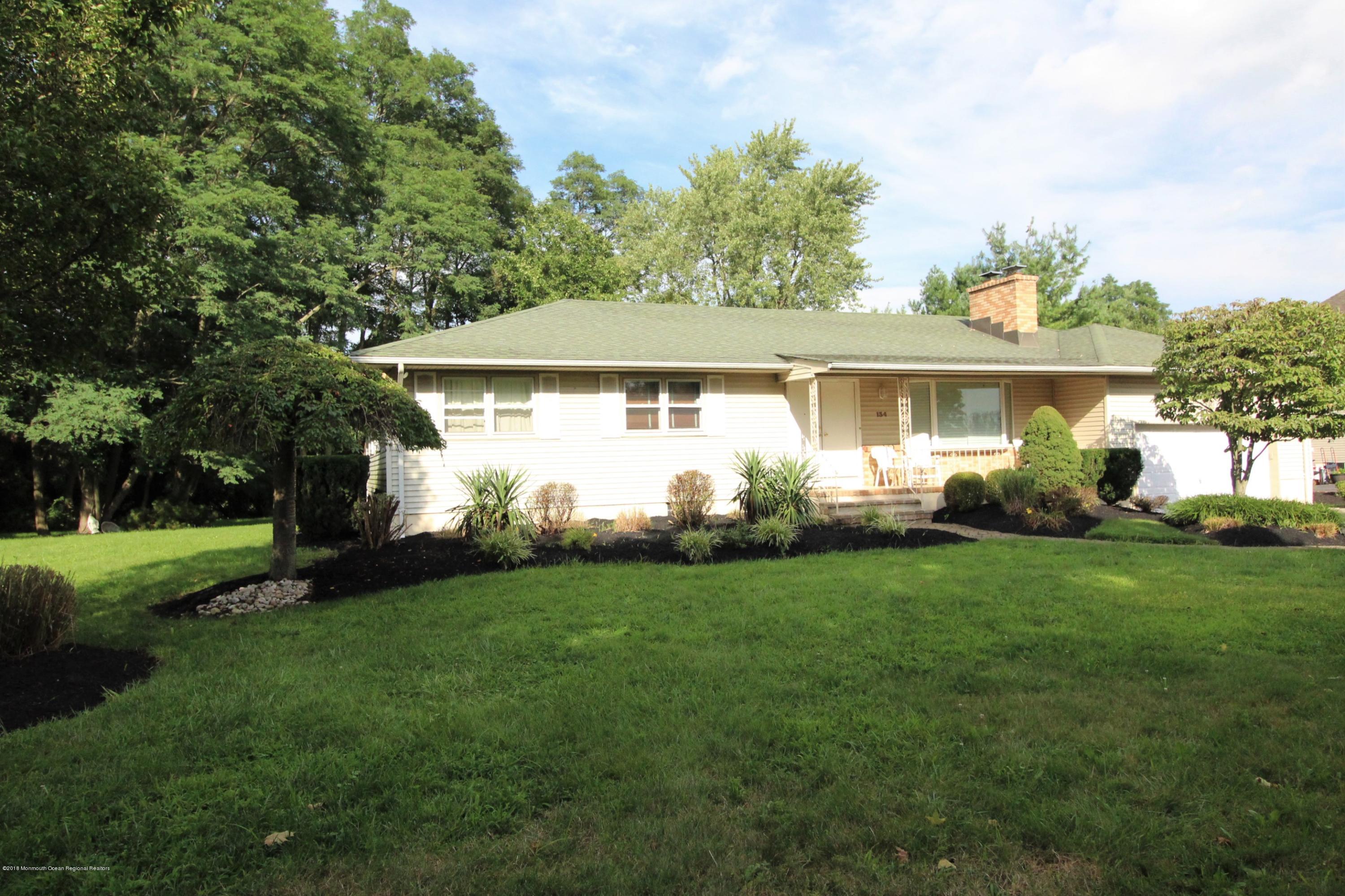 134 Conover Road Morganville, NJ 07751 - Photo 15 of 24 a front view of a house with a garden