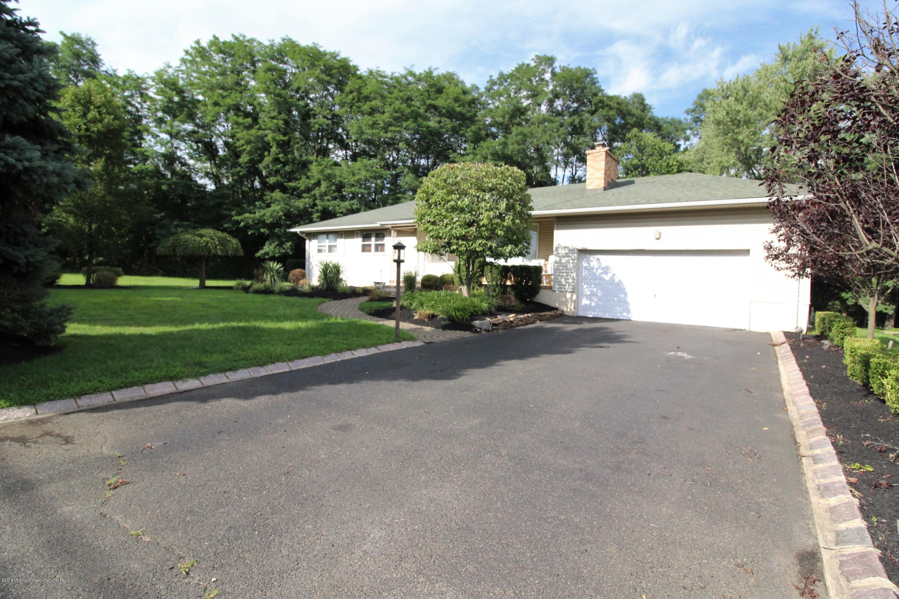 134 Conover Road Morganville, NJ 07751 - Photo 17 of 24 a front view of a house with a yard and garage