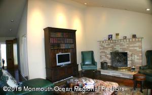 134 Conover Road Morganville, NJ 07751 - Photo 24 of 24 a living room with furniture a fireplace and a flat screen tv