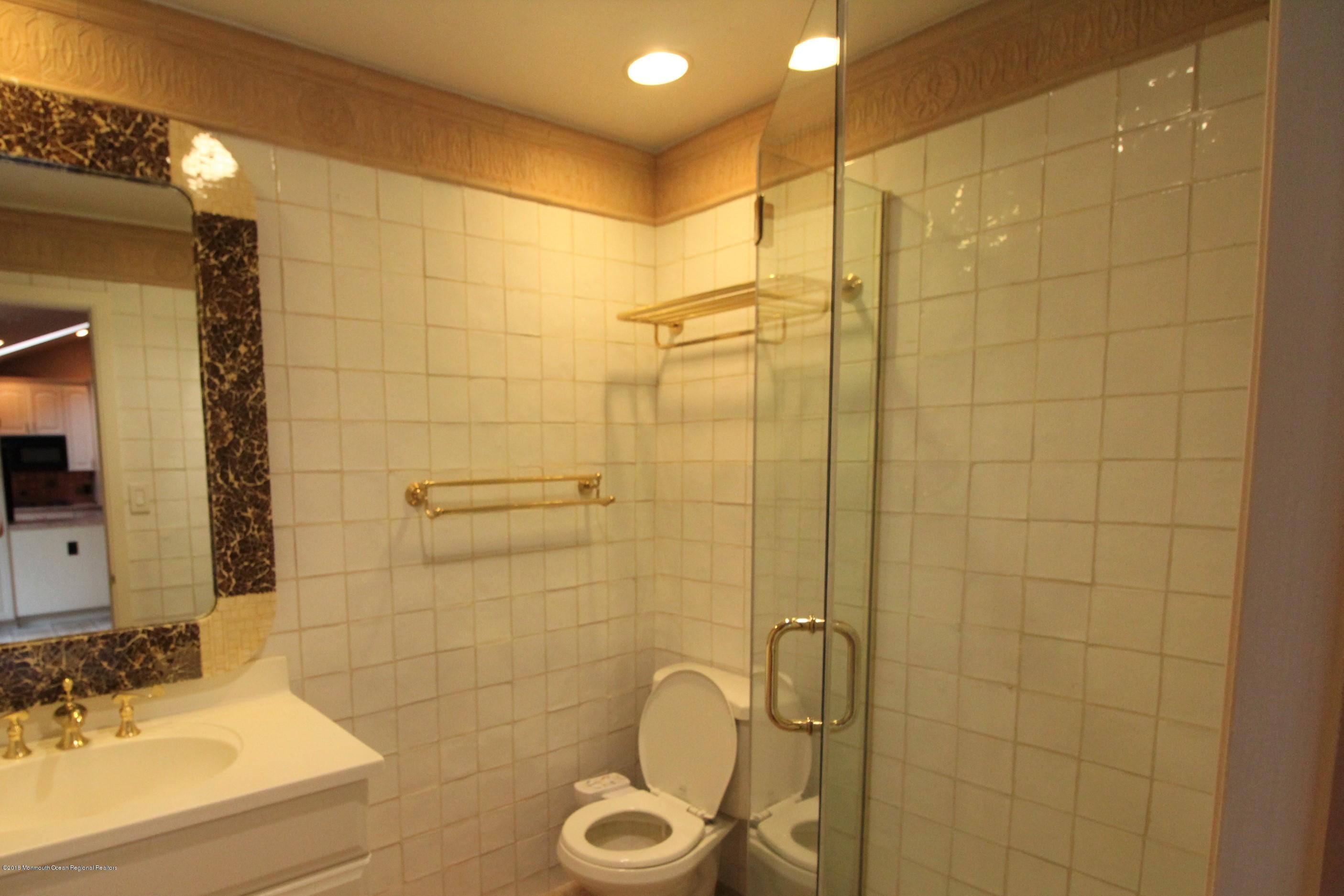 134 Conover Road Morganville, NJ 07751 - Photo 7 of 24 a bathroom with a shower sink and mirror