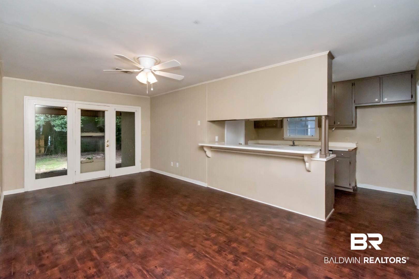 324 Judson Drive Mobile, AL 36608 - Photo 2 of 20 Unfurnished living room with dark wood finished floors, ceiling fan, and crown molding