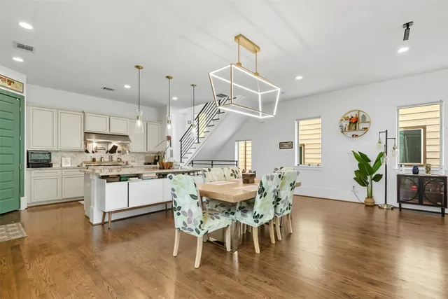 a large kitchen with a table and chairs