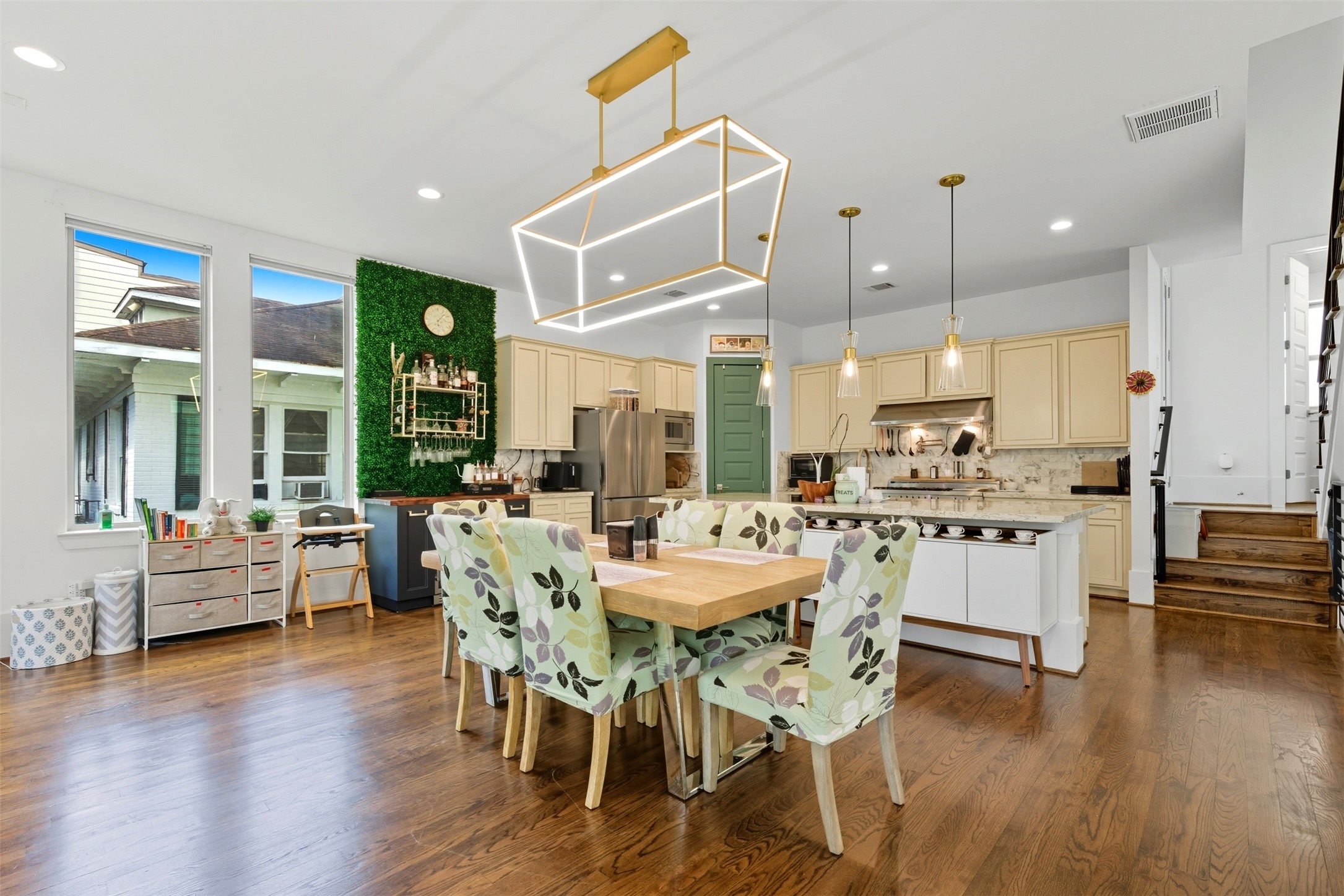 215 Avondale Street Houston, TX 77006 - Photo 13 of 42 a large kitchen with dining table chairs wooden floor and a large window