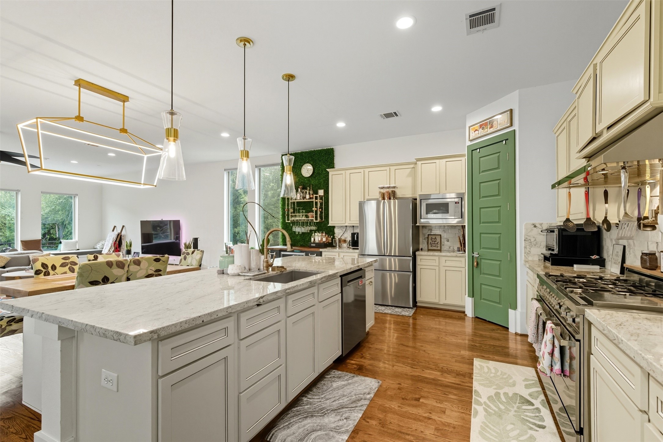 215 Avondale Street Houston, TX 77006 - Photo 18 of 42 a kitchen with a sink a counter top space stainless steel appliances and cabinets