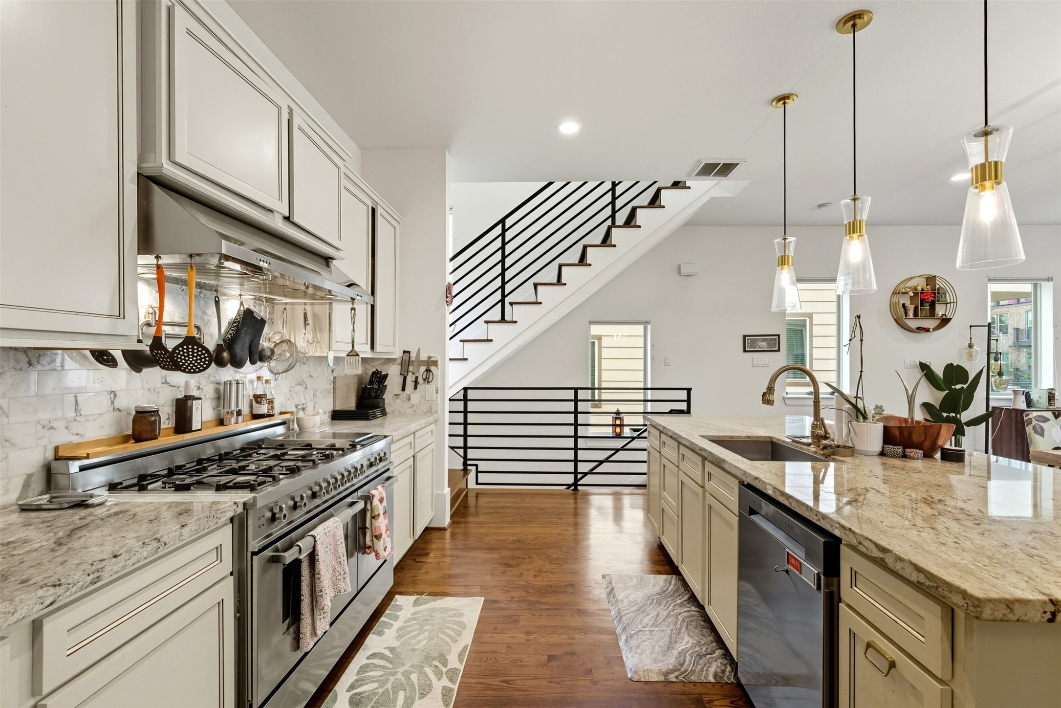 215 Avondale Street Houston, TX 77006 - Photo 19 of 42 a kitchen with stainless steel appliances granite countertop a sink a stove and a wooden floors