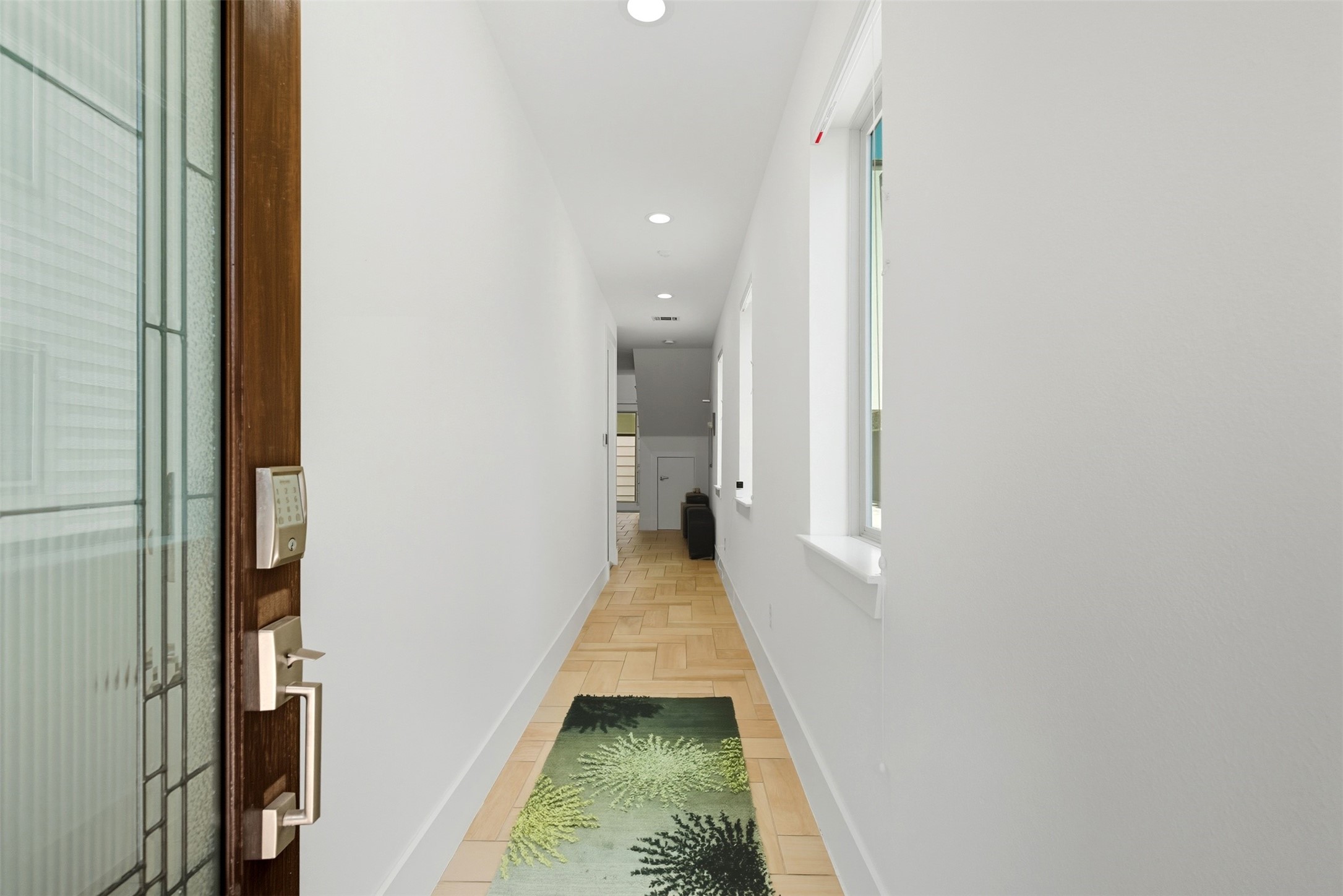 215 Avondale Street Houston, TX 77006 - Photo 2 of 42 a view of a hallway with wooden floor and a bathroom