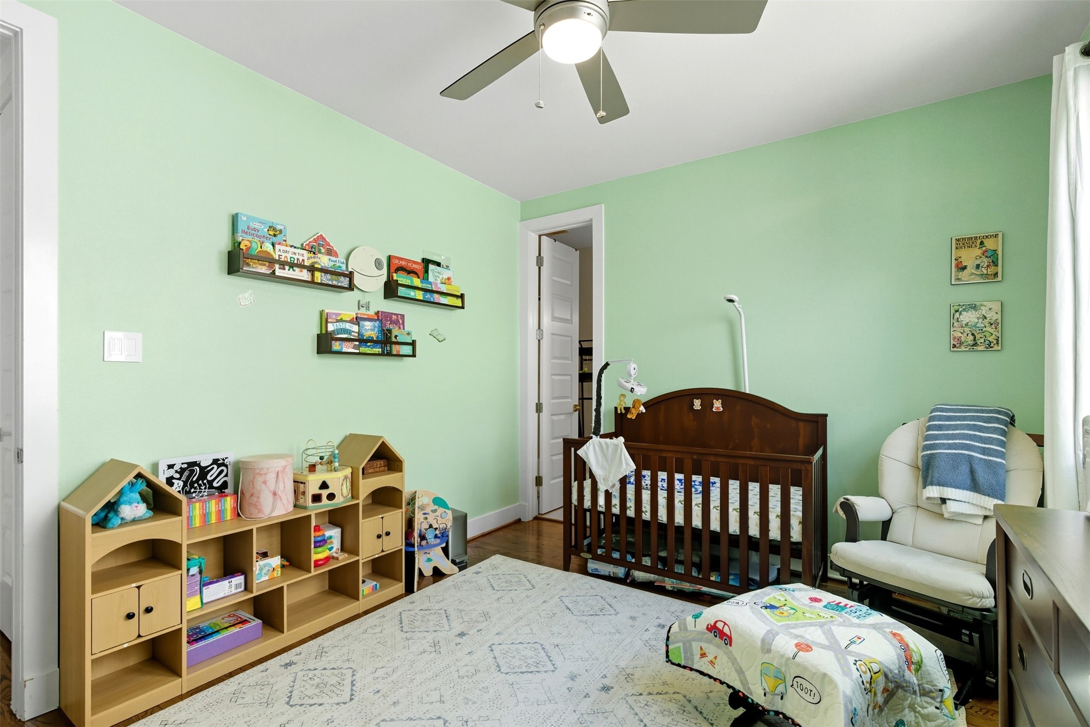 215 Avondale Street Houston, TX 77006 - Photo 30 of 42 a bedroom with a bed and a wooden floor