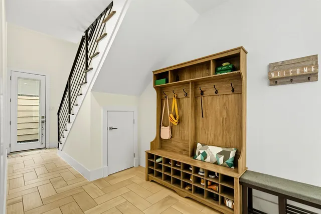 a view of front door with furniture and stairs