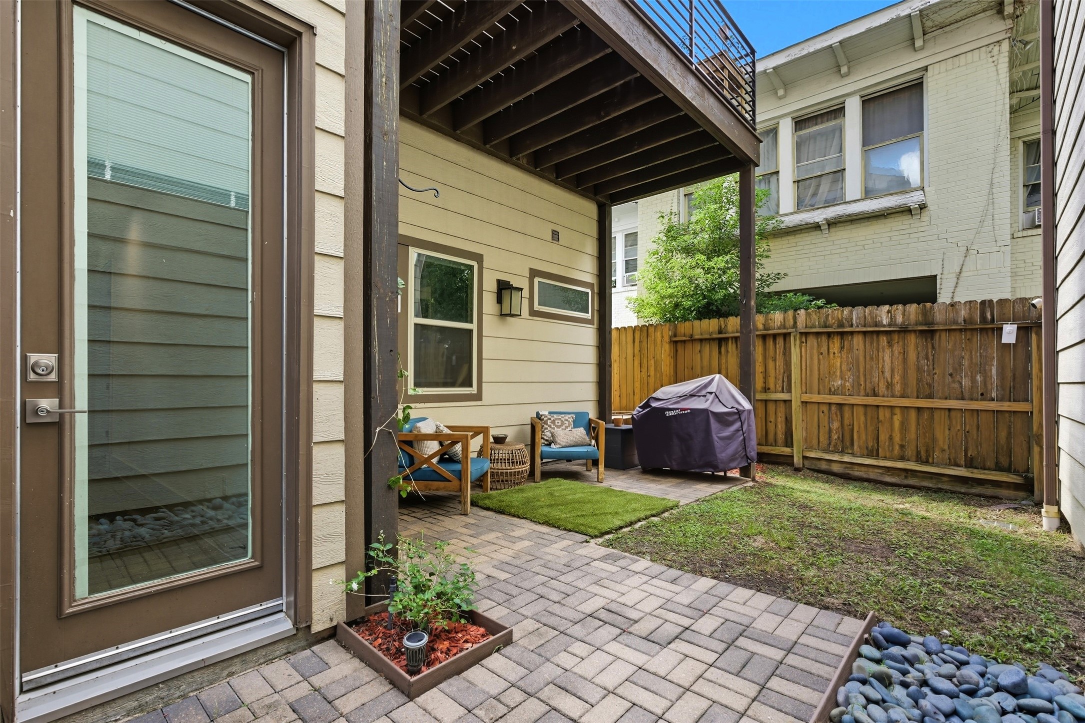 215 Avondale Street Houston, TX 77006 - Photo 35 of 42 a view of a chair and table in backyard of the house