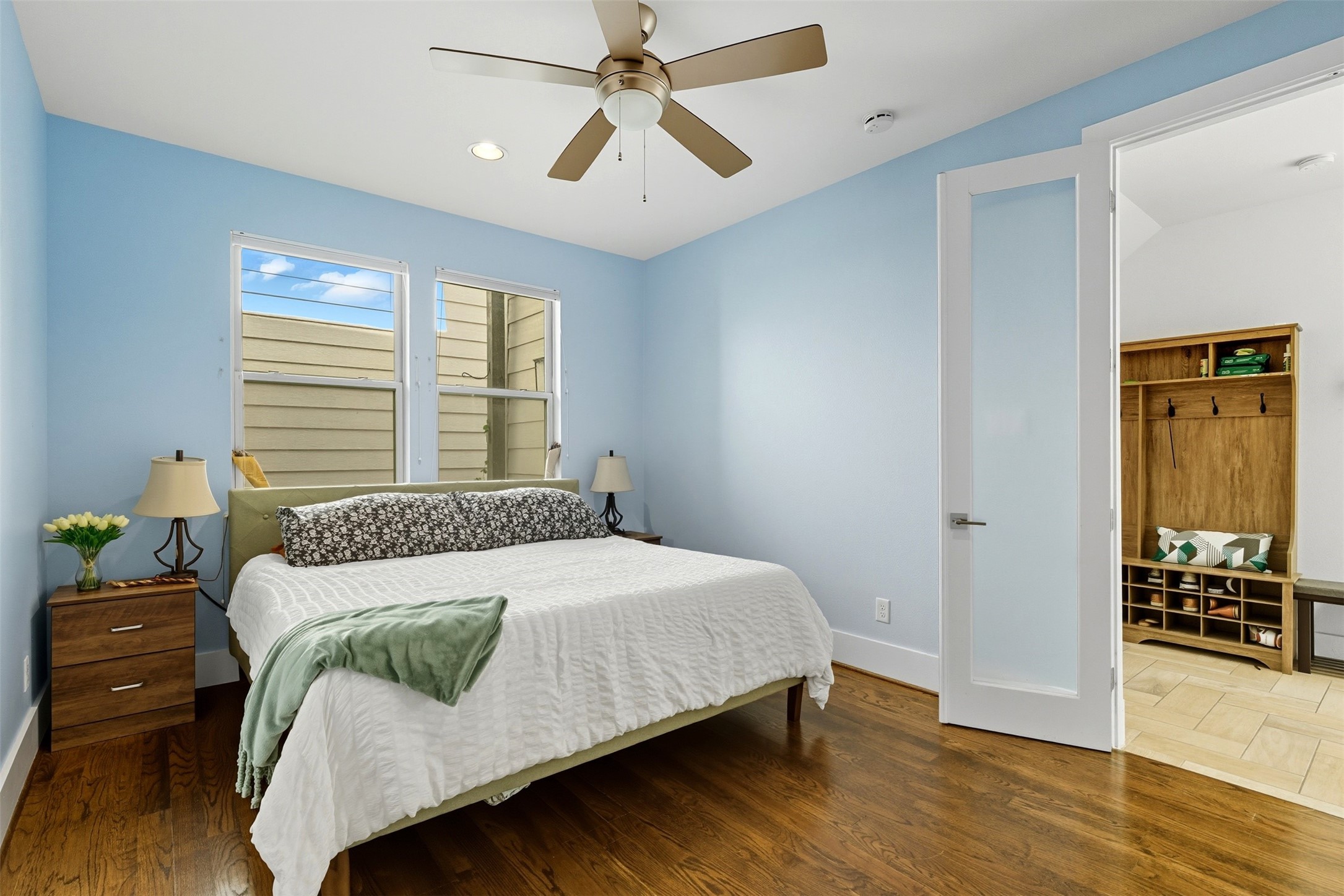 215 Avondale Street Houston, TX 77006 - Photo 5 of 42 a bedroom with a bed and wooden floor