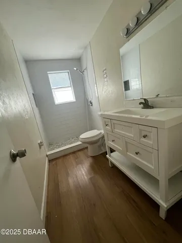 a bathroom with a sink a toilet and mirror