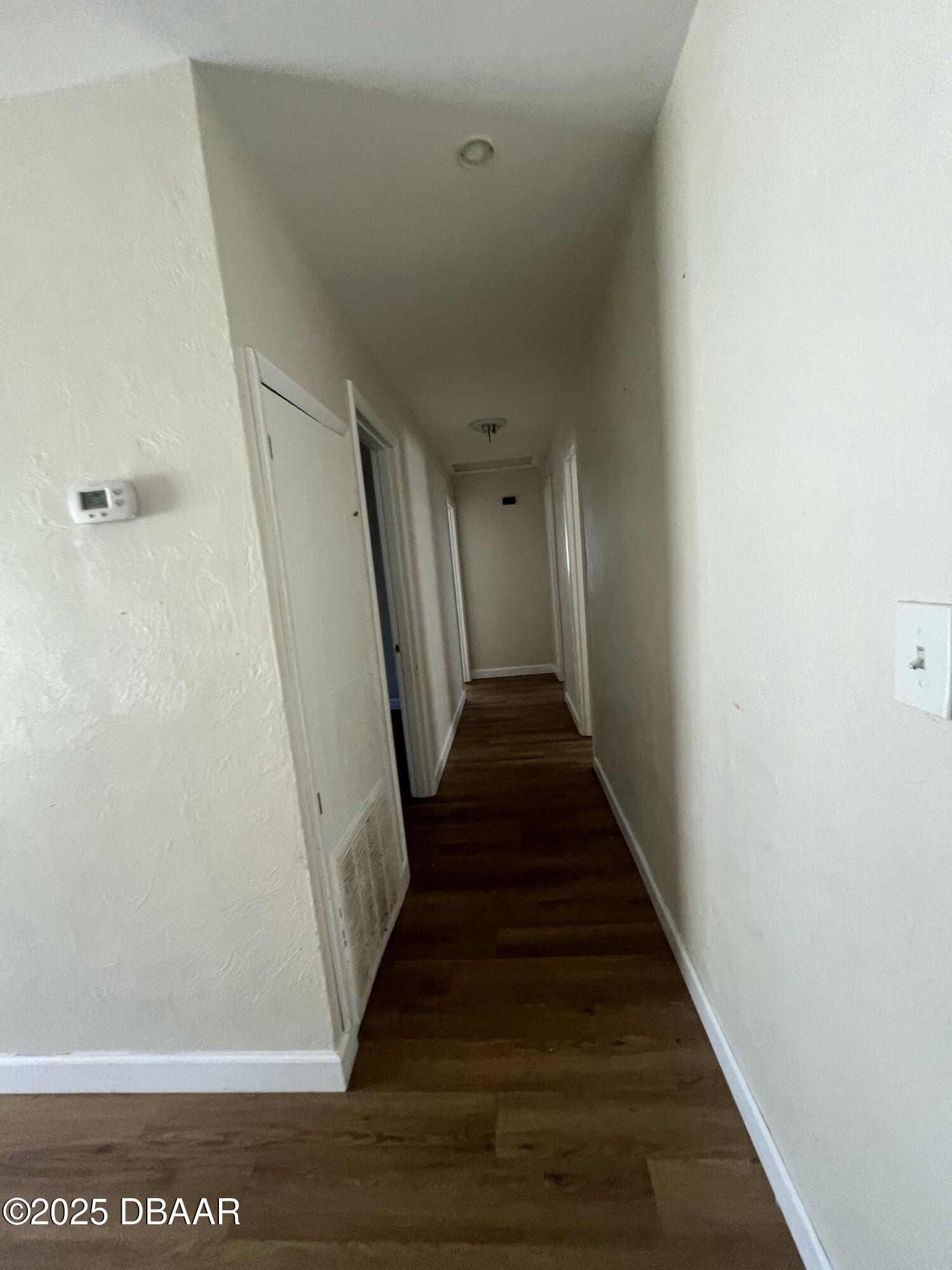 536 Ruth Street Daytona Beach, FL 32114 - Photo 4 of 10 a view of a hallway with wooden floor and staircase