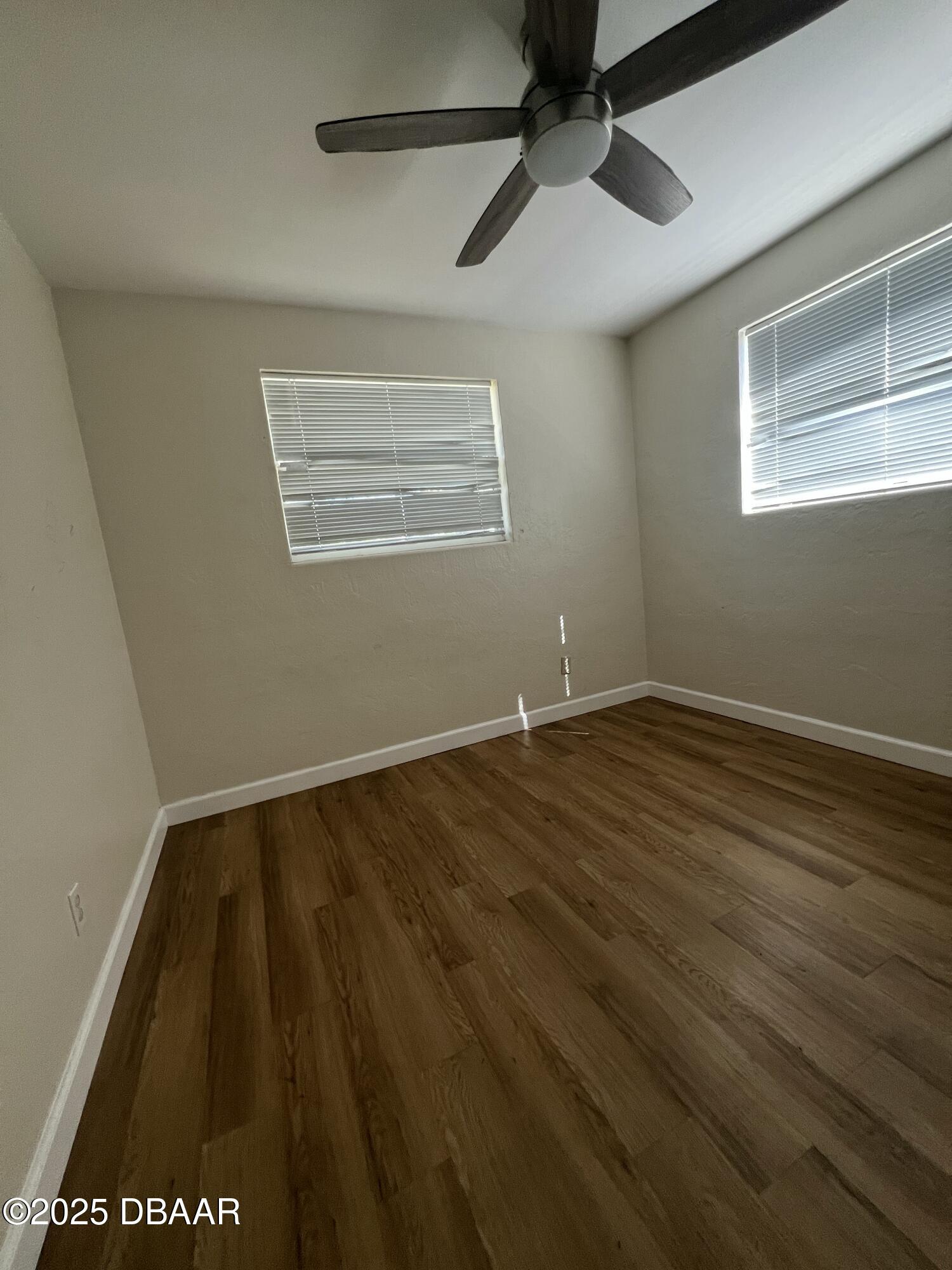 536 Ruth Street Daytona Beach, FL 32114 - Photo 9 of 10 a view of an empty room with wooden floor and a window