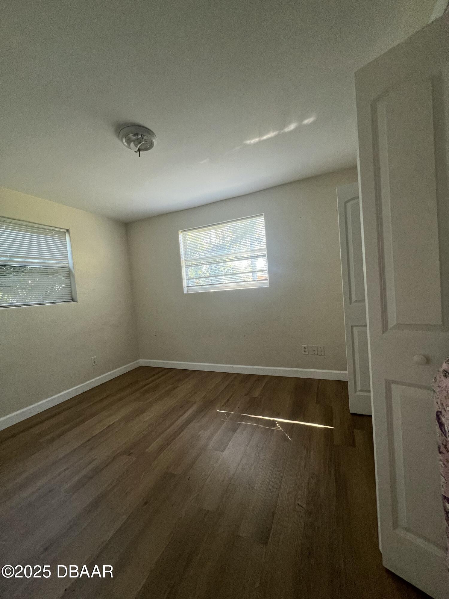 536 Ruth Street Daytona Beach, FL 32114 - Photo 10 of 10 a view of an empty room with wooden floor and a window