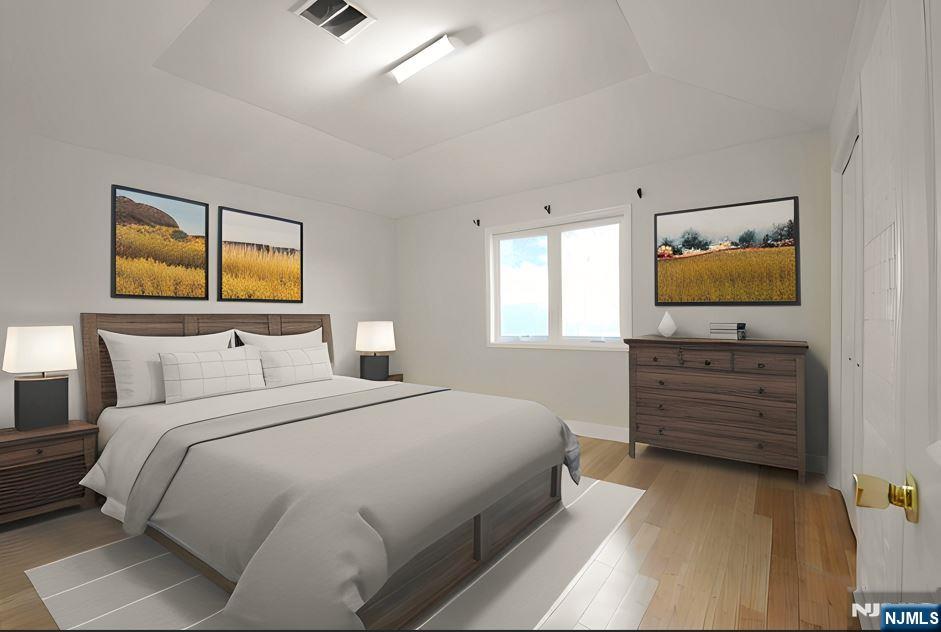 12 Pulaski Place, Unit A Hackensack, NJ 07601 - Photo 12 of 29 a bedroom with a bed and a flat screen tv