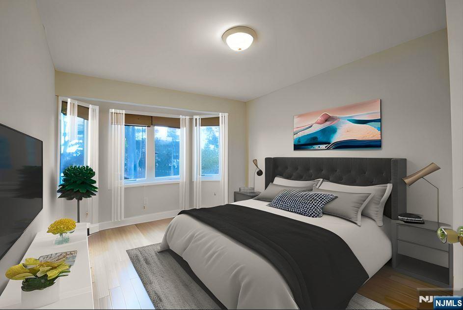 12 Pulaski Place, Unit A Hackensack, NJ 07601 - Photo 18 of 29 a bedroom with a bed and a couch