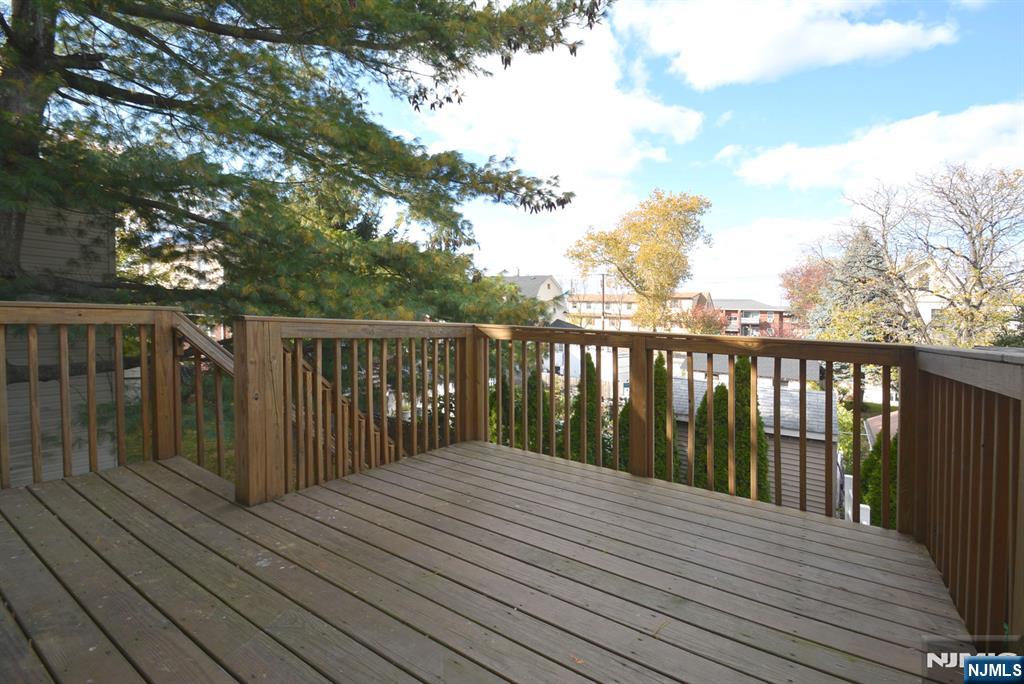 12 Pulaski Place, Unit A Hackensack, NJ 07601 - Photo 27 of 29 a balcony with wooden floor and fence