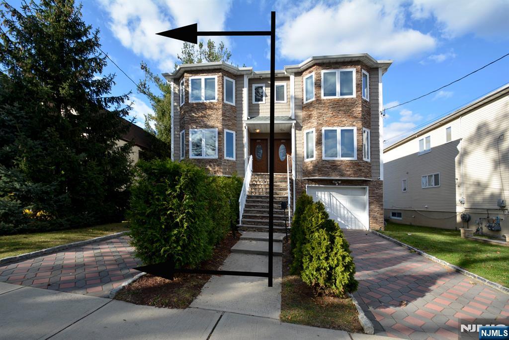 12 Pulaski Place, Unit A Hackensack, NJ 07601 - Photo 28 of 29 a front view of a house with garden