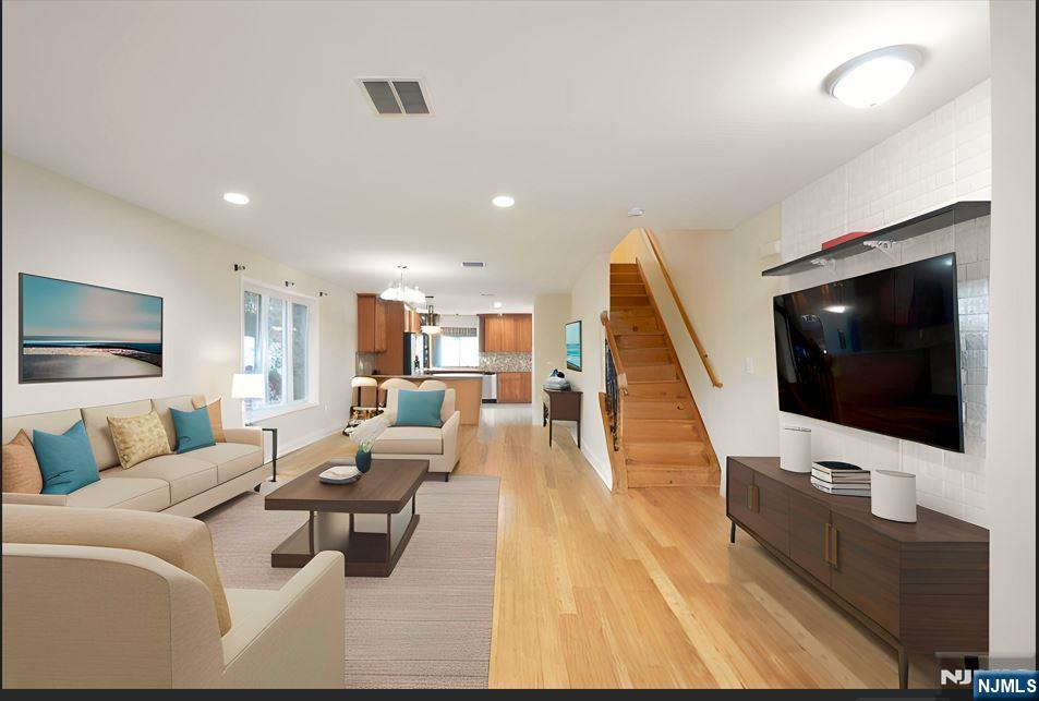 12 Pulaski Place, Unit A Hackensack, NJ 07601 - Photo 3 of 29 a living room with furniture and a flat screen tv