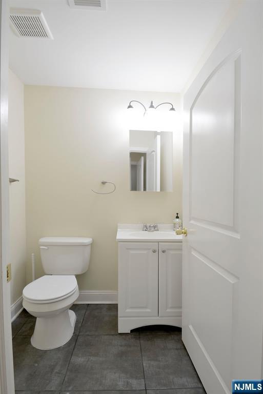 12 Pulaski Place, Unit A Hackensack, NJ 07601 - Photo 9 of 29 a bathroom with a toilet sink and mirror