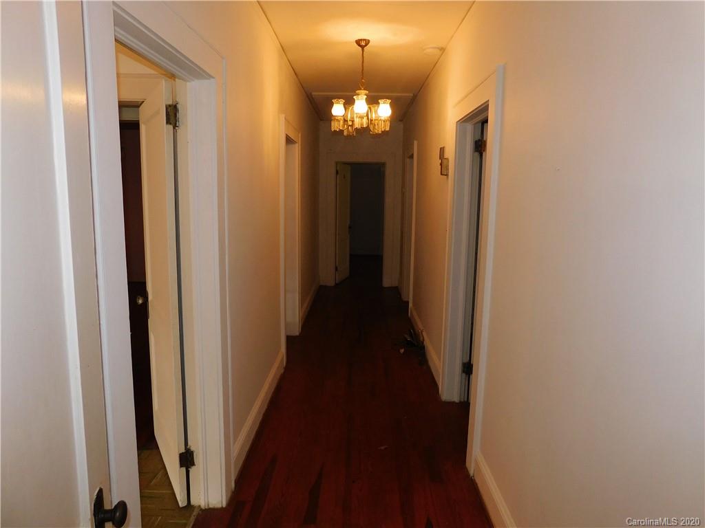 1382 Springdale Road, Unit 7 Lancaster, SC 29720 - Photo 17 of 31 a view of a hallway with wooden floor and chandelier