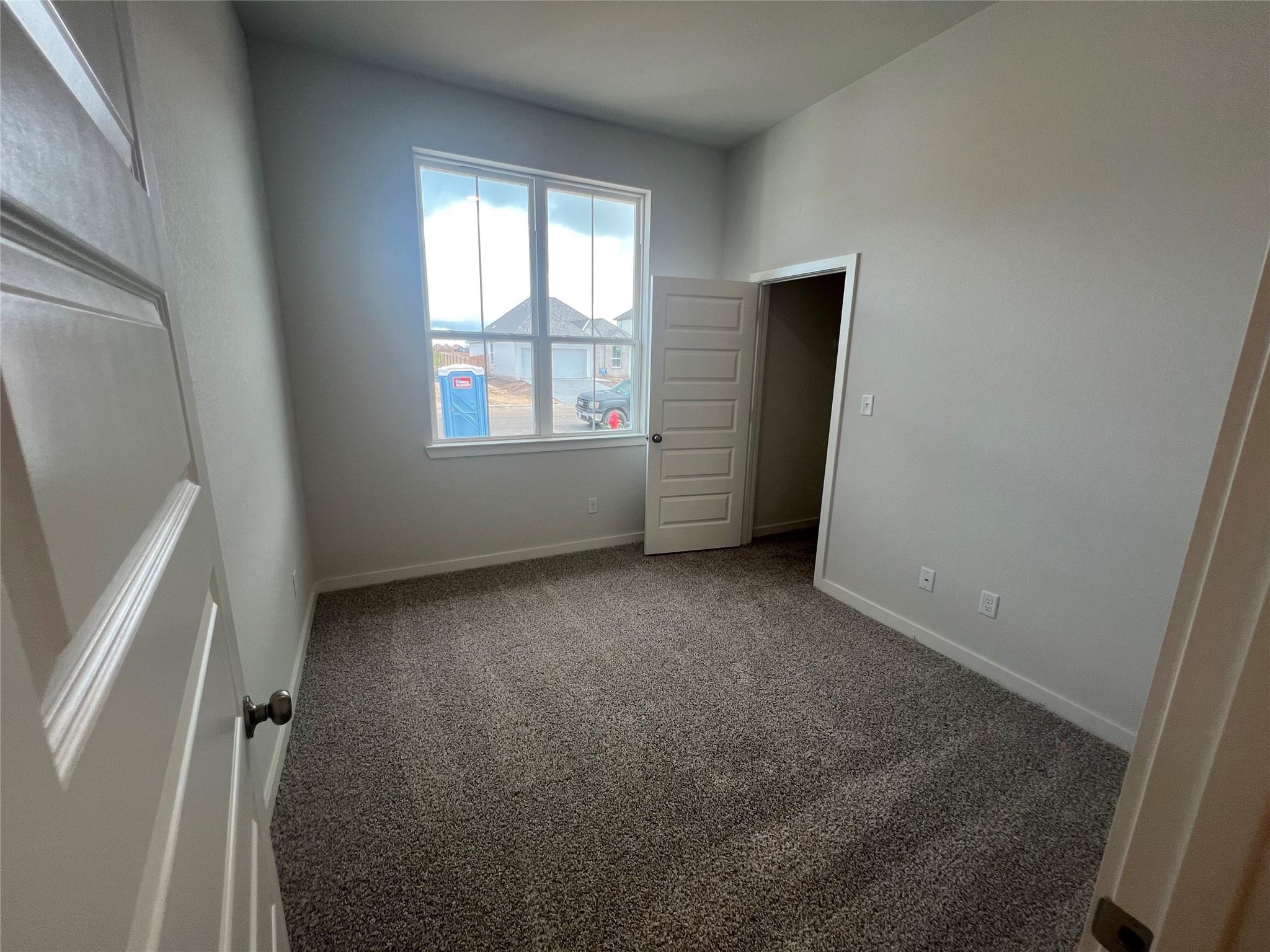 255 Gus Loop Georgetown, TX 78626 - Photo 5 of 24 A well-lit room awaits your personal touch, featuring soft carpet and ample natural light.