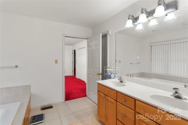 a bathroom with a double vanity sink and a mirror