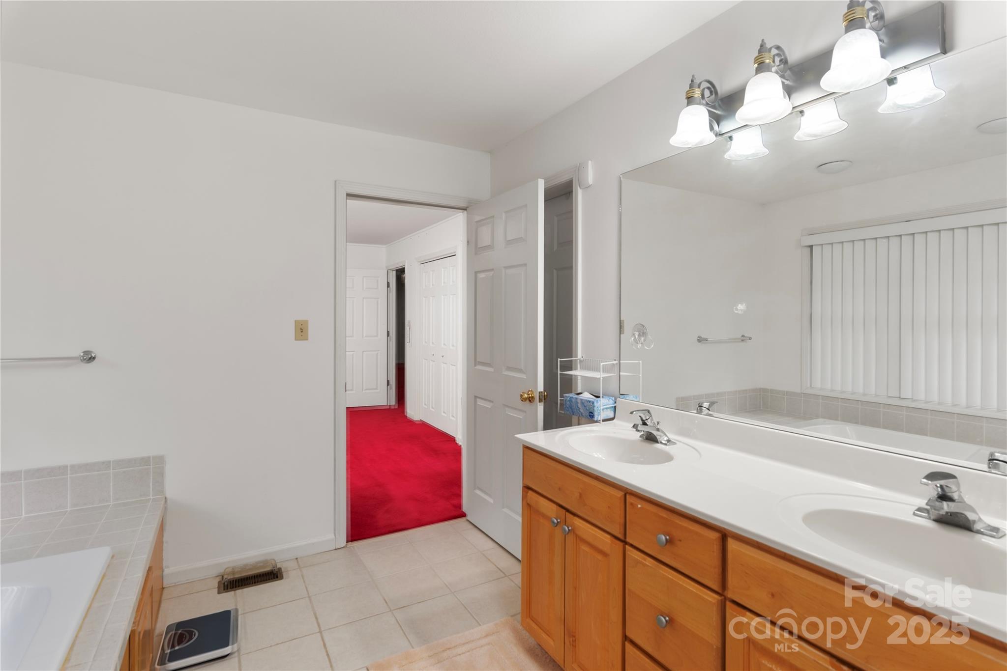 98 Choga Ridge Whittier, NC 28789 - Photo 18 of 28 a bathroom with a double vanity sink and a mirror
