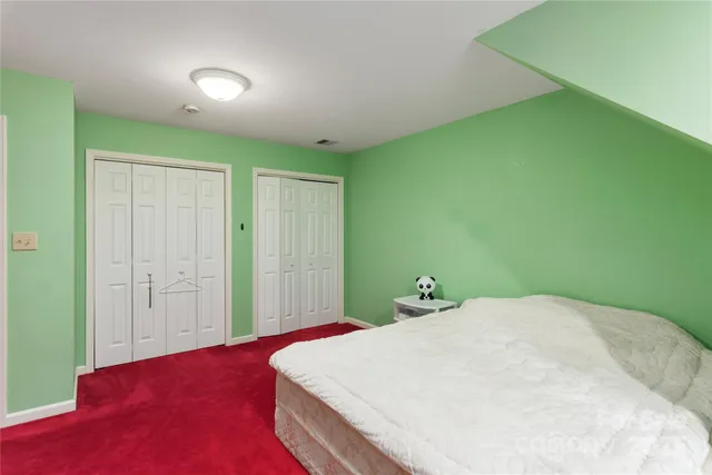 a bedroom with a bed and a closet