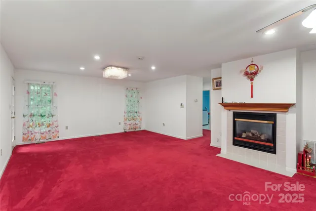 a view of an empty room with a fireplace