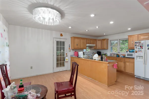 a kitchen with stainless steel appliances granite countertop a sink counter space and a window
